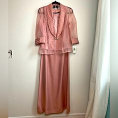 Nwt Alex Evenings 2 Piece Set Formal Gown. Dress Is A Shimmery Pink Color. The Top Of This Sleeveless Gown Is A Crinkly Fabric With A Blouson Effect And The Skirt Is A Beautiful Fall Of Smooth Pink Shimmery Fabric. The Jacket Is Mostly Sheer With 3/4 Sleeves. The Wrist And Lapel Are The Same Fabric As The Top Of The Dress. Jacket Has Jeweled Broach Closure. This Dress Is Lined. Measurements Are Flat Lay And Approximate Bust 18.5 In. Waist 16in. Length 58in. Two Piece Skirt Set Formal, Lace Top Gown, Gown With Jacket, One Piece Gown, Front Knot Dress, Black Evening Gown, Long Formal Gowns, Alex Evenings, Sleeveless Gown