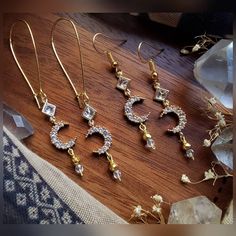 Listing is for ONE (1) pair of earrings.  These beautiful crescent moon earrings are crafted with gold plated pyrite beads, gold plated crystal moon charms, glass diamond shaped charms, Czech faceted glass beads, & matching hoops + your preference of hook style. ▪︎▪︎▪︎▪︎▪︎ * (Quantity: ONE (1) pair each - Though others may be recreated similarly, it may take longer depending on supply inventory, please contact me.) * Please note that as each product is handmade, each one will be unique and one o Gold Crescent Earrings With Moon Phase Detail, Gold Crescent Cartilage Earrings Nickel Free, Gold Half Moon Celestial Earrings, Gold Moon Phase Earrings, Gold Cartilage Earrings With Moon Charm For Gift, Gold Cartilage Earrings With Moon Charm, Gold Moon-shaped Earrings With Moon Charm, Gold Crescent Spiritual Earrings, Gold Celestial Crystal Earrings With Moon Charm