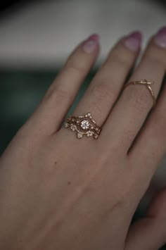 a woman's hand with two rings on it