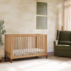 a baby's room with a chair and crib