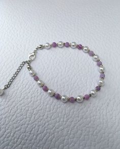 Delicate pearl bracelet, purple agate gemstone and white pearls, adjustable. This dainty pearl bracelet is simple and elegant. Glass pearls are coated in coloured lacquer to give a beautiful lustre finish. A beautiful gift for any occasion. Comes in its own gift box. Purple Pearl Bracelet As A Gift, Adjustable Crystal Bracelet With Pearl Charm, Elegant Purple Pearl Bracelet With Round Beads, Elegant Purple Adjustable Bracelets, Purple Pearl Bracelet As Gift, Elegant Handmade Purple Pearl Bracelet, Adjustable Elegant Purple Crystal Bracelet, Handmade Elegant Purple Pearl Bracelet, Adjustable Purple Pearl Bracelet As Gift