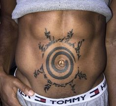 a man's stomach with tattoos on it and the words tommy written in black ink