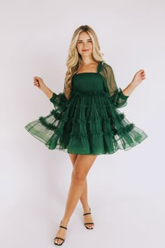 Be the belle of any ball in this hunter green EXCLUSIVE Hopeless Romantic Dress. Flirt with style in the ruched bodice, tulle overlay, sheer puff sleeve, and ruffle details. Look your lively best for your romantic night out! Details *Measurements are taken with item hanging and fabric unstretched.* Lined Long sheer puff sleeves Square neckline Elastic along shoulders Invisible zipper back closure Tier hem Sizing Approximate measurements: 29" SIZE LENGTH BUST* WAIST* 0 31" 29" 2 31" 30" 26" 4 31. Mini Hunter Green Dress, Short Green Formal Dresses, Semi Formal Green Dress, Homecoming Dress Sleeves, Maid Of Honor Dress Green, Forest Green Homecoming Dresses, Hoco Dresses With Sleeves, Formal Christmas Party Dress, Work Christmas Party Dress