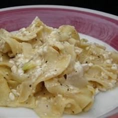 a plate with pasta and chicken salad on it