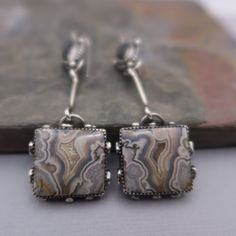 Pretty and Unique Crazy Lace Agate and Hematite set in sterling silver.  These earrings measure 3 inches long and 3/4 inches wide at the widest point.  All components are sterling silver and have been oxidized and polished.  Each earring weighs:  10.8 and 11.3 grams Thanks for shopping!! Artisan Silver Earrings With Natural Stones, Silver Bohemian Agate Earrings, Bohemian Silver Agate Earrings, Silver Agate Drop Earrings, Silver Agate Jewelry With Matching Earrings, Elegant Silver Agate Earrings, Nickel-free Silver Agate Earrings, Silver Agate Gemstone Earrings, Pierced Silver Agate Jewelry