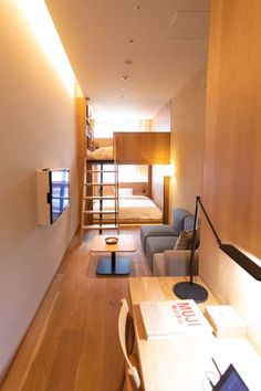 this is an image of a long narrow living room with bunk beds in the background