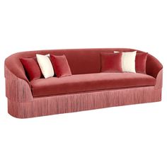 a red couch with two pillows on it