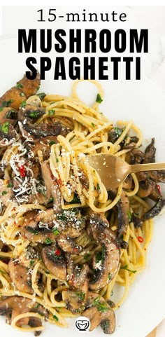 a white plate topped with pasta covered in mushrooms and parmesan sprinkles