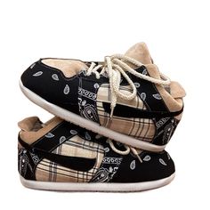 two black and white shoes on top of each other, one with a bandana print