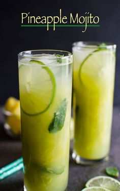 two glasses filled with lemonade and lime slices