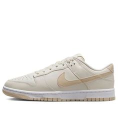 The Nike Dunk Low 'Light Bone Tan' is a stylish sneaker crafted from full-grain leather with a mesh tongue and lining. The Light Bone base is complemented by tan Swooshes, heel, tongue branding, insoles and rubber outsole. The white midsole and heel feature a white “NIKE” embroidered branding. This sneaker is perfect for everyday wear and is inspired by the classic Dunk series. The tan colorway adds a subtle touch of style to any outfit. With its timeless design, the Nike Dunk Low 'Light Bone Tan' is sure to be a hit. Nike Urban Sneakers With Gum Sole, Cream Sneakers With Perforated Toe Box For Streetwear, Cream Leather Sneakers For Streetwear, Urban Cream Sneakers For Streetwear, Cream High-top Sneakers With Contrast Sole For Sports, Nike Casual Sneakers With Boost Midsole, Nike Sneakers With Perforated Toe Box For Streetwear, Custom Cream Sneakers With Rubber Sole For Sports, Casual Nike Sneakers With Boost Midsole