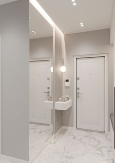 an empty bathroom with two sinks and mirrors