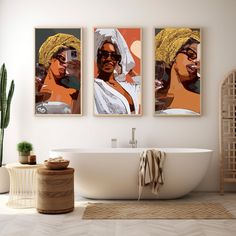 two framed art prints on the wall above a bathtub