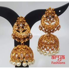 Golden Triple Jhumka Earring with golden beads Premium Quality Kundan Jhumka Earrings Length: Approx. 2.65" Light-weight Push-Back closure Gold Finish on high-quality brass as the base metal, Kundan stones and Pearls Suitable for any traditional or contemporary attire and occasion In-stock & ready-to-ship **Color may vary slightly due to photography and lighting. Gold Temple Jewelry Chandbalis With Latkans, Gold Chandbalis With Latkans In Temple Jewelry Style, Ceremonial Gold Plated Jhumkas With Latkans, Gold Temple Jewelry Chandbalis, Gold Temple Jewelry Earrings For Navratri, Ceremonial Heavy Gold Danglers, Gold Plated Chandbalis With Latkans For Festivals, Gold Chandbali Jhumkas For Ceremonial Occasions, Gold Chandbali Jhumkas For Ceremonial Events