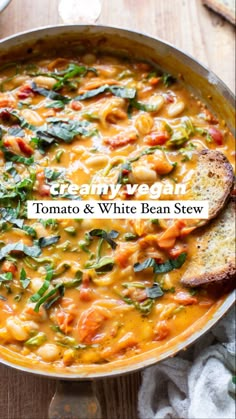 Copper pot with plant-based creamy tomato and white bean stew, with two slices of gluten free bread tucked in on the right side of the stew. Drizzled with olive oil and garnished with fresh basil. Bean Stew Vegan, Tomato White Bean, White Bean Stew, Stew Vegan, Vegan Stew, Vegan Soup Recipes, Bean Stew, Tasty Vegetarian Recipes, Vegan Soups