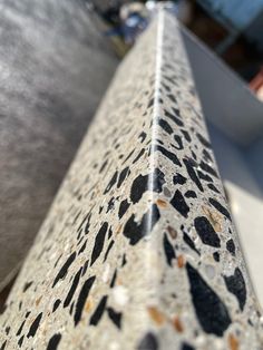 a close up view of the top of a metal pole with black and white spots on it