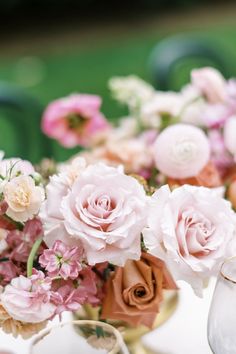 a table topped with lots of pink and white flowers