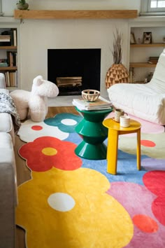 a living room filled with furniture and a fire place in the middle of the room