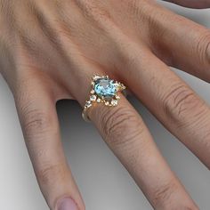 a woman's hand with a ring on it and a blue stone in the middle