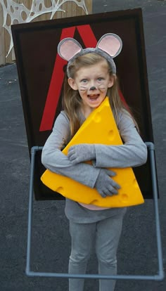 Mousetrap costume. made it with foam board with brown spray paint and red tape, pvc piping with gray spray paint for the trap bar, I bent 2 metal hangers for the strap to hold it on her back, cheese hat and grey clothes and ears. Easy costume to make and Emily won 1st place in 3 different contest. Diy Mouse Costume, Kids Mouse Costume, Mouse Costume Diy, Brown Spray Paint, Easy Costumes To Make, Cheese Costume, World Book Day Outfits, Kids Dress Up Costumes, Last Minute Kostüm