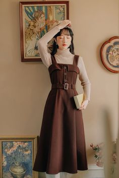 Midi pinafore dress with thick shoulder straps, button front, belted waist, side pockets and pleated skirt. Concealed back zipper. S: 33" chest, 27" waist, 42" lengthM: 34.5" chest, 28.5" waist, 42" lengthL: 36" chest, 30" waist, 42.5" lengthXL: 37.5" chest, 31.5" waist, 42.5" length Winter Dark Academia, Dark Academia Dress, Preppy Style Women, Academia Dress, Midi Pinafore Dress, Court Fashion, Conservative Dresses, Winter Dark, Dresses Autumn