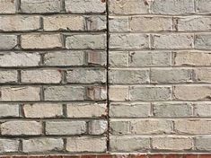 an old brick wall that has been painted white