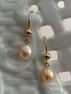 Stunning High-Luster beautiful plump pearls. Freshwater Akoya Teardrop Pearl Earrings, adorned with gorgeous nacre. These high-quality pearls, produced in the 1950s, are sure to captivate your attention.  Grown in freshwater estuaries in Australia, these pearls are cultivated in the same oysters (Pinctada Fukata) as their saltwater Akoya counterparts. The result is a breathtaking iridescent nacre that adds an extra touch of elegance to these pearls. Abandoned in a warehouse for over fifty years, these pearls have now emerged back into the world, ready to be admired and cherished. Each pearl possesses its own unique beauty, making them truly one-of-a-kind treasures. I sort, select, and match each pair at my bench in Palm Springs.  All my earring mounts are made in the US by a certified meta Teardrop Pearl Earrings, June Birthday, Purple Pearl, Unique Beauty, Wire Earrings, Palm Springs, The 1950s, Fresh Water, Jewelry Earrings Dangle