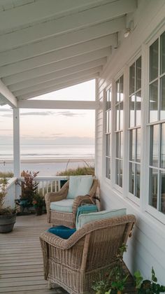 the porch is covered with wicker furniture