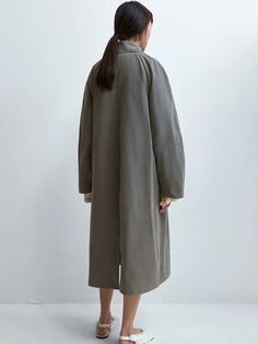 The Cordera Wax Cotton Trench in Taupe Grey is a unique and special rainy trench coat that is light and water repellent. Designed with a relaxed fit and long length, it's a perfect piece for the in-between season. Detailed with covered buttons and two ornamental pockets. 50% cotton / 39% polyester / 16% polyamide Hand wash or dry clean Made in Spain — Cordera, founded by sisters Mónica and María in 2008, has cultivated a distinct identity rooted in minimalism and ethical production practices. Ne Long Coat For Workwear In Rainy Season, Long Coat For Work During Rainy Season, Oversized Solid Color Raincoat For Fall, Oversized Solid Raincoat For Fall, Oversized Long Raincoat For Fall, Spring Oversized Waterproof Outerwear, Spring Oversized Outerwear For Rainy Weather, Oversized Raincoat For Rainy Fall Weather, Oversized Outerwear For Rainy Spring Weather