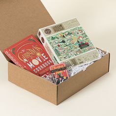 an open box with books inside on a white surface