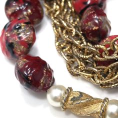 *Description: This is a beautiful Kramer red bracelet and clip earrings from the late 1940s to early 1950s. I tested the gold on the bracelet and it tested at 22K gold surface metal. The red beads are molded so they would be made of thermoset and they have gold glitter inside in places. There are two twisted gold beads with faux pearls on each side, three rows of gold chain on the bracelet with two rows of red art beads. The earrings have matching red solid beads with the same tones and are sign Vintage Bracelet With Round Beads For Party, Vintage Round Bead Bracelet For Parties, Vintage Round Bead Bracelets For Parties, Vintage Round Beaded Bracelet For Parties, Vintage Gold Beads Jewelry Gift, Vintage Yellow Gold Jewelry For Festive Occasions, Red Round Beads Jewelry For Evening, Red Beaded Evening Jewelry, Vintage Gold Beads Jewelry For Party