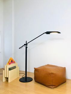 a floor lamp next to a brown bean bag