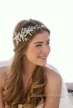 a woman wearing a bridal hair comb with starfishs on it's head