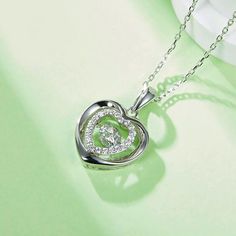 An eye-catching round moissanite dances with ease at the center of this appealing women's necklace, expressing your unstoppable love. Additional round gem set in sterling silver frame the center. Features Moissanite was originally found in meteorites(Chemical name: Silicon Carbide). It was first discovered in 1893, while a scientist was examining meteor samples from a crater in Arizona. After many years, the experts has been recreated moissanite in the laboratory, that make the gemstone with fri Cubic Zirconia Necklace With Center Stone For Gift, Silver Round Necklace With Center Stone, Silver Jewelry With Heart Cut Halo Design, Silver Heart Cut Jewelry With Halo Design, Silver Sterling Solitaire Necklace With Halo Design, Silver Solitaire Necklace With Halo Design In Sterling Silver, Dazzling Necklace With Center Stone As Gift, Dazzling Necklace With Center Stone For Gift, Silver Diamond Necklaces With Center Stone