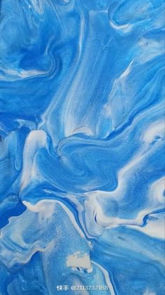 blue and white fluid painting on canvas with watercolors in the bottom right corner