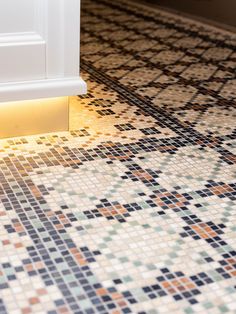 a close up of a bathroom floor with a door