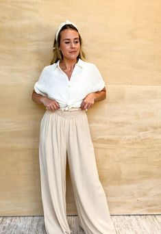 Introducing our Flow Down Pants: perfect for a carefree summer day! The flowy, wide leg design and elastic waist provide both comfort and style. These taupe pants will add a touch of effortless elegance to any outfit. Get ready to flow! Ashley is 5'4" and is wearing a size medium. Straight Leg Flowy Pants, Tan Palazzo Pants Outfit, Relaxed Spring Harem Pants, Ankle-length, Relaxed Ankle-length Harem Pants For Spring, Spring Relaxed Ankle-length Harem Pants, Relaxed Spring Ankle-length Harem Pants, Rayon Wide Leg Pants For Summer Day Out, Spring Beach Wide Leg Pants, Casual Summer Flowy Skirt Bottoms