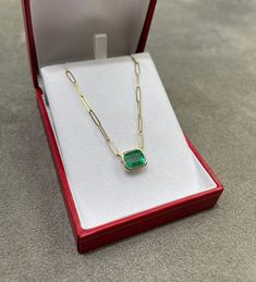 Featured here is a 2.80-carat stunning, East to West emerald necklace in 14K yellow gold. Displayed in the center is a light spring green emerald with excellent eye clarity, accented by a simple bezel setting, allowing for the emerald to be shown in full view. The earth mined emerald has a desirable lush green color with excellent qualities. An 18-inch paper clip chain is attached to the emerald pendant. This necklace is ideal for everyday use and is the perfect accessory for any outfit. Setting Gold Emerald Necklace, Necklace Emerald, Jupiter Fl, Emerald Pendant, Colombian Emeralds, Emerald Necklace, Emerald Engagement, Light Spring, Silver Engagement Rings