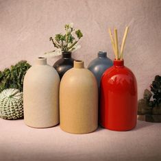 several vases are lined up next to each other