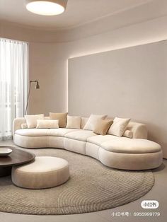 a living room filled with furniture next to a large white couch and round coffee table