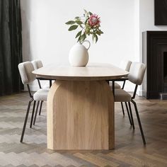 a table with chairs and a vase on it