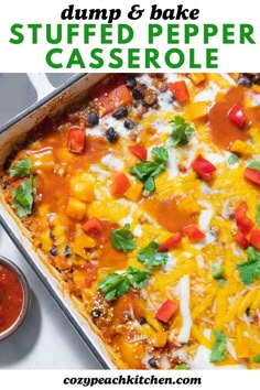 a casserole dish with cheese, tomatoes and black olives on top in a pan