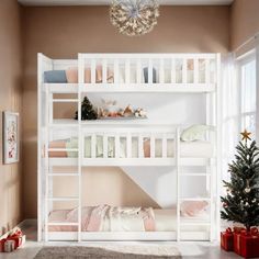 a white bunk bed sitting next to a christmas tree