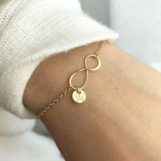 This infinity bracelet makes the perfect gift for a best friend or loved one.Show you mean forever with the infinity symbol, and customize it with their initial on a dainty disk. Item Details: • This listing is for ONE(1) Infinity bracelet.• Made in a 14K shiny gold plate over sterling silver and 925 sterling silver.• Infinity pendant - shiny finish, measures 19mm.• Tiny cute 6mm 22ga disk.• Letter style, Block font or Cursive font (default), upper case or lower case. Waterproof - We make those Trendy Infinity Jewelry Gift, Trendy Infinity Jewelry For Gift, Trendy Infinity Jewelry, Elegant Infinity Jewelry For Friendship, Personalized Infinity Jewelry, Dainty Infinity Bracelet For Everyday Wear, Minimalist Name Bracelet For Bridesmaid Gift, Dainty Infinity Bracelet For Everyday, Minimalist Infinity Jewelry For Friendship