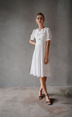 "This design linen dress is perfect for summer and fall! 100 % designed and handmade by Emsilk. I am pleased to offer your garments made to measure at no extra cost. * Detail: - Collared neckline - Coconut buttons on the front - Small gathered decoration on the front - Fit and flare bottom - Fully lined - Invisible zipper on the back - Below the knee length - High quality linen, washed linen, soft linen - The model is 5'6\" tall and wearing size S. * Care: - Dry clean or machine washed with cold White Puff Sleeve Vintage Dress For Summer, Summer Workwear Knee-length Puff Sleeve Dress, Modest Short Sleeve Summer Dress, Elegant Vintage Short Sleeve Summer Dress, Linen Puff Sleeve Dress For Daywear, Cottagecore Summer Puff Sleeve Dress With Gathered Sleeves, Cottagecore Puff Sleeve Dress With Gathered Sleeves For Summer, Knee-length Vintage Summer Dress, Summer Linen Midi Dress With Gathered Sleeves