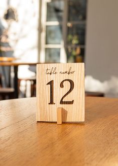 a wooden table with a sign on it that says twelve eleven and the number twelve twelve