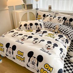 mickey mouse bedding set with black and white checkered bedspread on wooden floor