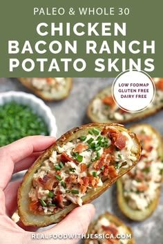 a person holding up a baked potato with bacon and ranch on it, in front of other food items