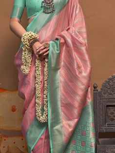 Introducing our enchanting pink weaving silk event wear saree with a blouse, the perfect choice for celebrating upcoming festivals, events, and any special occasion with a touch of ethnic elegance. This stunning saree features intricate zari weaving work that adds a touch of glamour and sophistication to your look. The pink color of the saree is vibrant and eye-catching, perfect for making a statement wherever you go.
The saree comes with a teal green color silk blouse that also features zari we Pink Dola Silk Traditional Wear For Ceremonies, Pink Pre-draped Saree With Unstitched Blouse For Traditional Ceremonies, Pink Traditional Wear Dola Silk For Ceremonies, Semi-stitched Pink Pre-draped Saree For Traditional Ceremonies, Pink Traditional Wear For Ceremonies In Dola Silk, Pink Dola Silk Handloom Blouse Piece, Pink Dola Silk Blouse Piece With Zari Weaving, Pink Banarasi Silk Traditional Wear With Unstitched Blouse, Pink Dola Silk Saree For Traditional Ceremonies