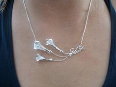 I've fabricated a few Calla Lilies in a pendant necklace form! I've handmade three lilies complete with stems and have them roped together in a trio. The pendant has a jump ring incorporated, on one side, and there's a hidden small bail on the other side, to which a chain is attached. The pendant will lay sideways so that the calla lilies are blooming upwards, towards the heart. The piece is approximately 3 inches in length from tip to end. Each are handmade, by me, so subtle variances will occu Unique Silver Necklaces For Mother's Day, Artistic Silver Necklace For Anniversary, Handmade Sterling Silver Necklace For Wedding, Artistic Silver Necklace For Wedding, Lilly Flower, Floral Statement Necklace, Artisan Necklace, Calla Lilies, Silver Box